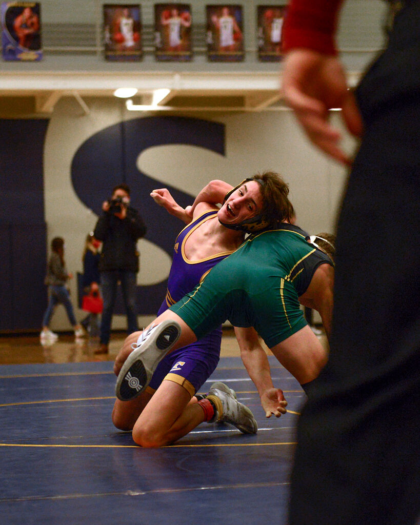 Hickman's Ethan Barr, left, wrestles Rock Bridge's Carter McCallister